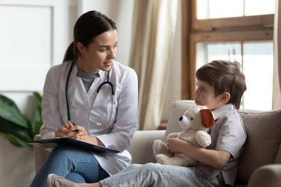 Doctor consulting with child at clinic